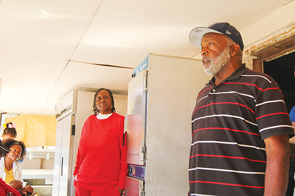 SARAH CAVACINI/Palatka Daily News – East Palatka resident Sharon Austin listens to fellow resident Ralph Dallas Jr. talk about life growing up in the East Palatka community. 