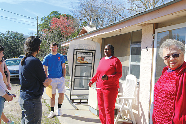 SARAH CAVACINI/Palatka Daily News – Sharon Austin talks to University of Florida law students outside of the former Austin’s Groceries in East Palatka on Friday.