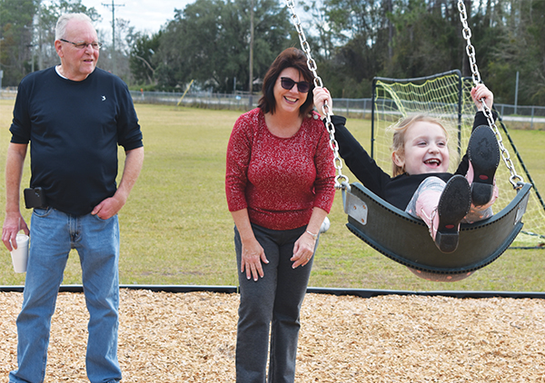 BRANDON D. OLIVER/Palatka Daily News – Commissioner Leota Wilkinson pushes her granddaughter, 4-year-old Lyndie Wilkinson, on the new swings. 