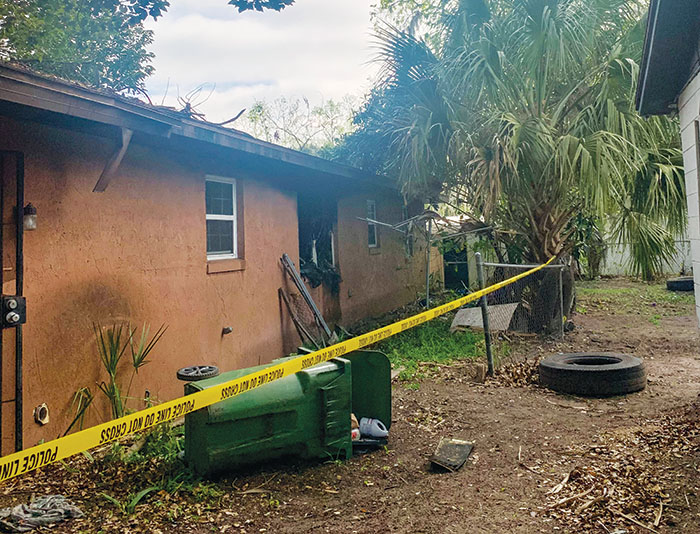 Police tape is wrapped around the home at 1019 Washington St. in Palatka on Monday following a structure fire that killed three people.