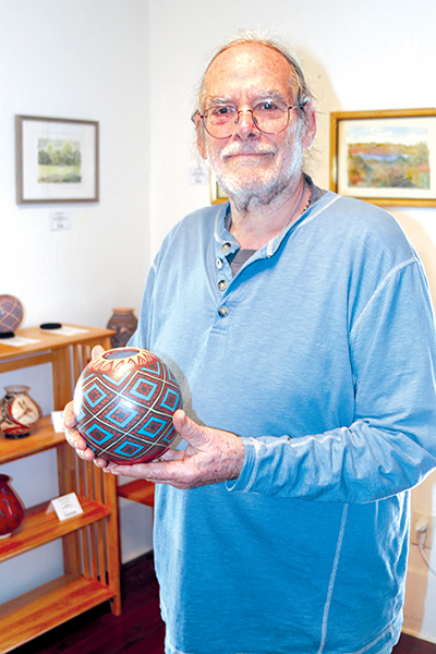 TRISHA MURPHY/Palatka Daily News – Bruce Waite, the executive director of the Melrose Center’s Studios of Melrose gallery, holds a handcrafted piece of art that is on display in his shop.