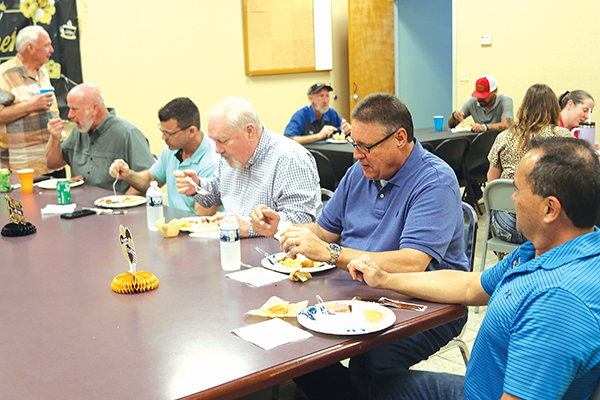 TRISHA MURPHY/Palatka Daily News – Hal Magee, second from right, eats lunch with his co-workers at a retirement party to celebrate his 36 years of service. 