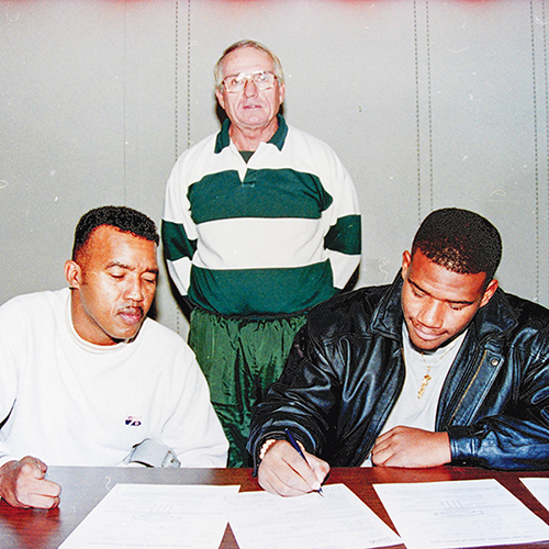 Daily News archive photo – Jim McCool, center, a former Palatka High School baseball and football coach, oversees a Palatka High School football player, right, on signing day in the 1990s.