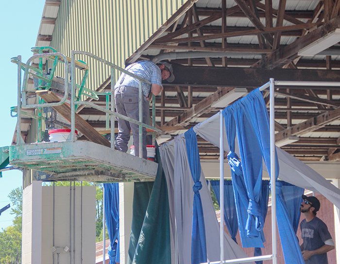 Crews work on last-minute adjustments Thursday to get ready for opening day of the Putnam County Fair.