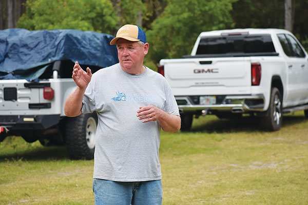 BRANDON D. OLIVER/Palatka Daily News – County Commissioner Bill Pickens talks to nearly 40 volunteers who gathered in Bunnell on Wednesday to harvest heart of palm.