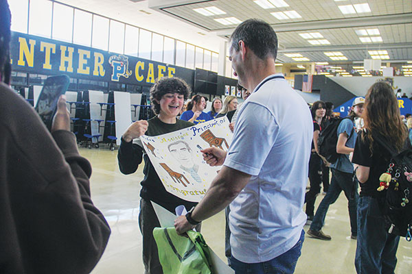 SARAH CAVACINI/Palatka Daily News – Palatka Junior-Senior High School Assistant Principal Michael Chaires signs a poster one of his students made about Chaires’ Assistant Principal of the Year award.