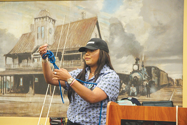 SARAH CAVACINI/Palatka Daily News – BassmastHER instructor Anastasia Patterson shows workshop attendees easy knots when tying fishing line to a rod before bass fishing.
