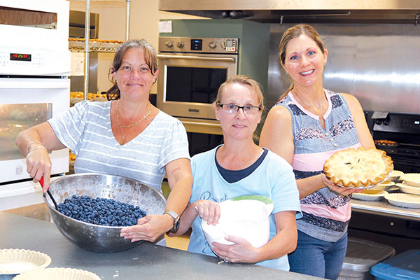 TRISHA MURPHY/Palatka Daily News – Pie-making volunteers, from left, Heidi Hockenberry, Dawn Rawls and Becky McLemore are ready for the challenge of making 600 pies for the Bostwick Blueberry Festival, which will be Saturday. 