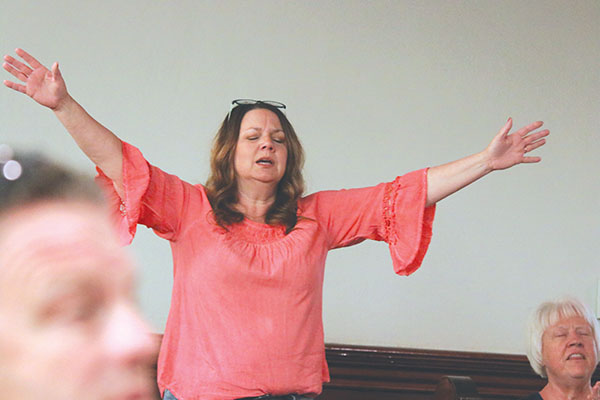 TRISHA MURPHY/Palatka Daily News – An local resident raises her hands in praise during the National Day of Prayer observance.