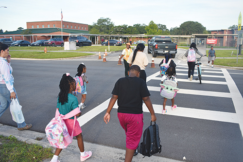 BRANDON D. OLIVER/Palatka Daily News -- A crossing guard makes sure students and parents get to Moseley Elementary School on Thursday, the first day of the academic year.