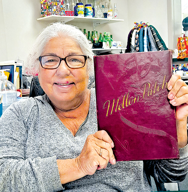 File photo – Sherrie A. Hunter, director of education for the Raleigh County Solid Waste Authority in Beckley, West Virginia, holds one of two Mellon High School yearbooks.