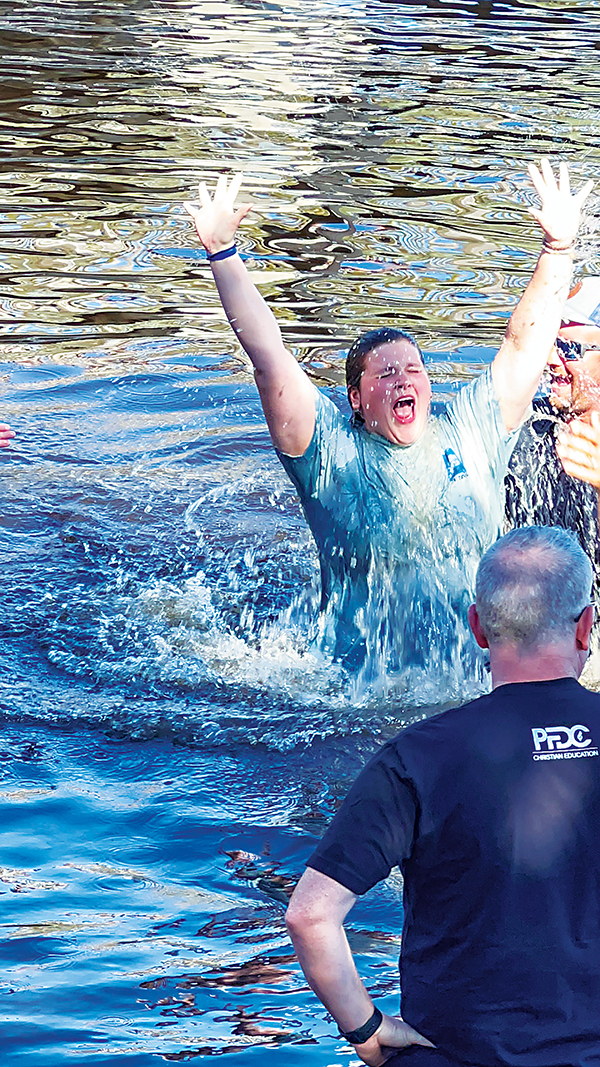 Photo submitted by Amylie Watts – Trinity Baptist Church member Amylie Watts throws up her hands Sunday after being baptized in the St. Johns River during the Community Baptism in Palatka.
