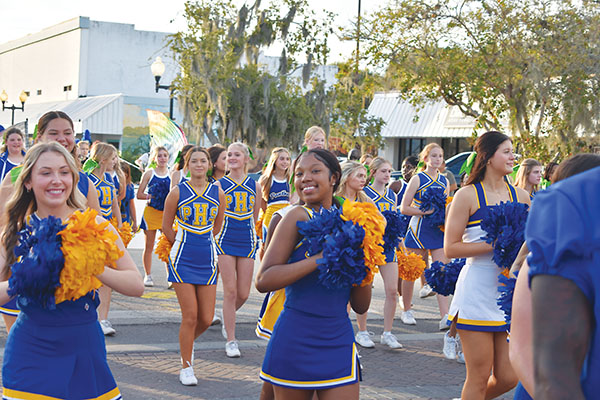 BRANDON D. OLIVER/Palatka Daily News –  Palatka Junior-Senior High School cheerleaders stroll St. Johns Avenue during the Homecoming Parade on Thursday.