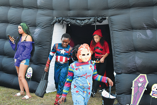 BRANDON D. OLIVER/Palatka Daily News – Costumed children emerge from a Palatka Police Department inflatable room during Trunk or Treat.