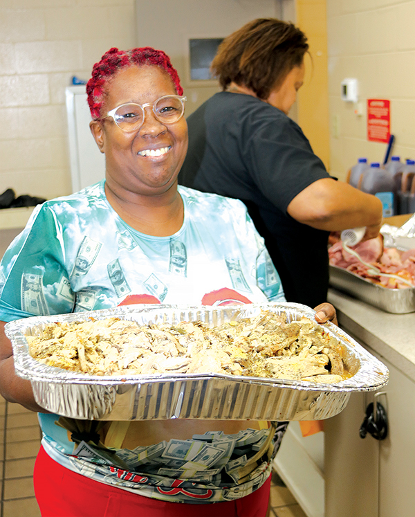 TRISHA MURPHY/Palatka Daily News – Marion Session holds a large pan of sliced turkey that was served Tuesday along with ham and all the fixings to area residents.