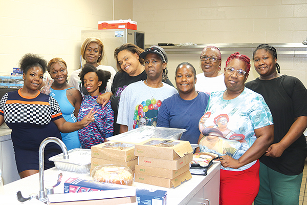 TRISHA MURPHY/Palatka Daily News – Volunteers at the meal giveaway take a break in between cooking and serving food Tuesday.