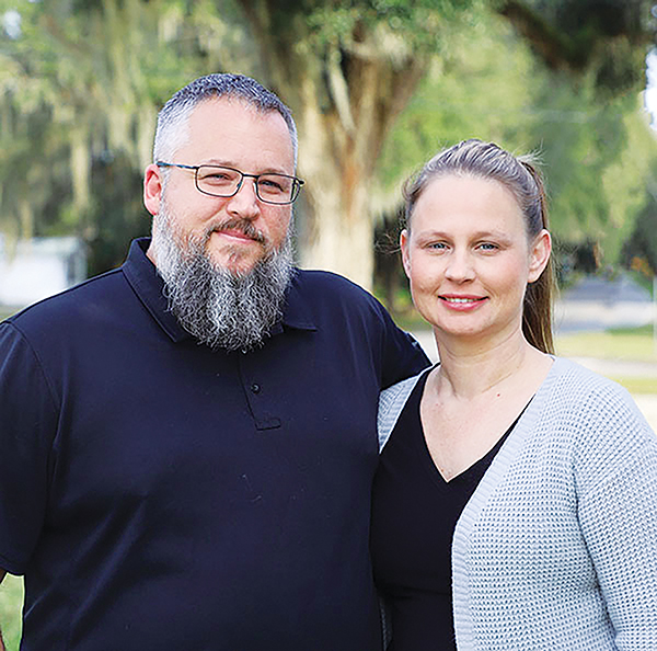 Photos submitted by Susan Kessler – Brett Corley, who is standing with his wife, Miranda Corley, graduated this week after attending the Palatka campus to become eligible to teach.