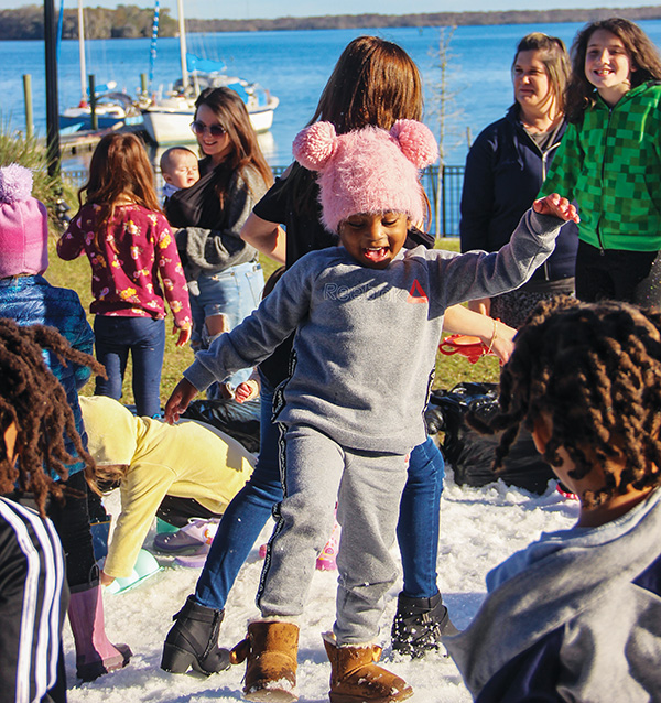 Children frolic in one of two snow areas at the 2022 Snow Day in Palatka. This year’s event will take place Friday at the Putnam County Fairgrounds in East Palatka.