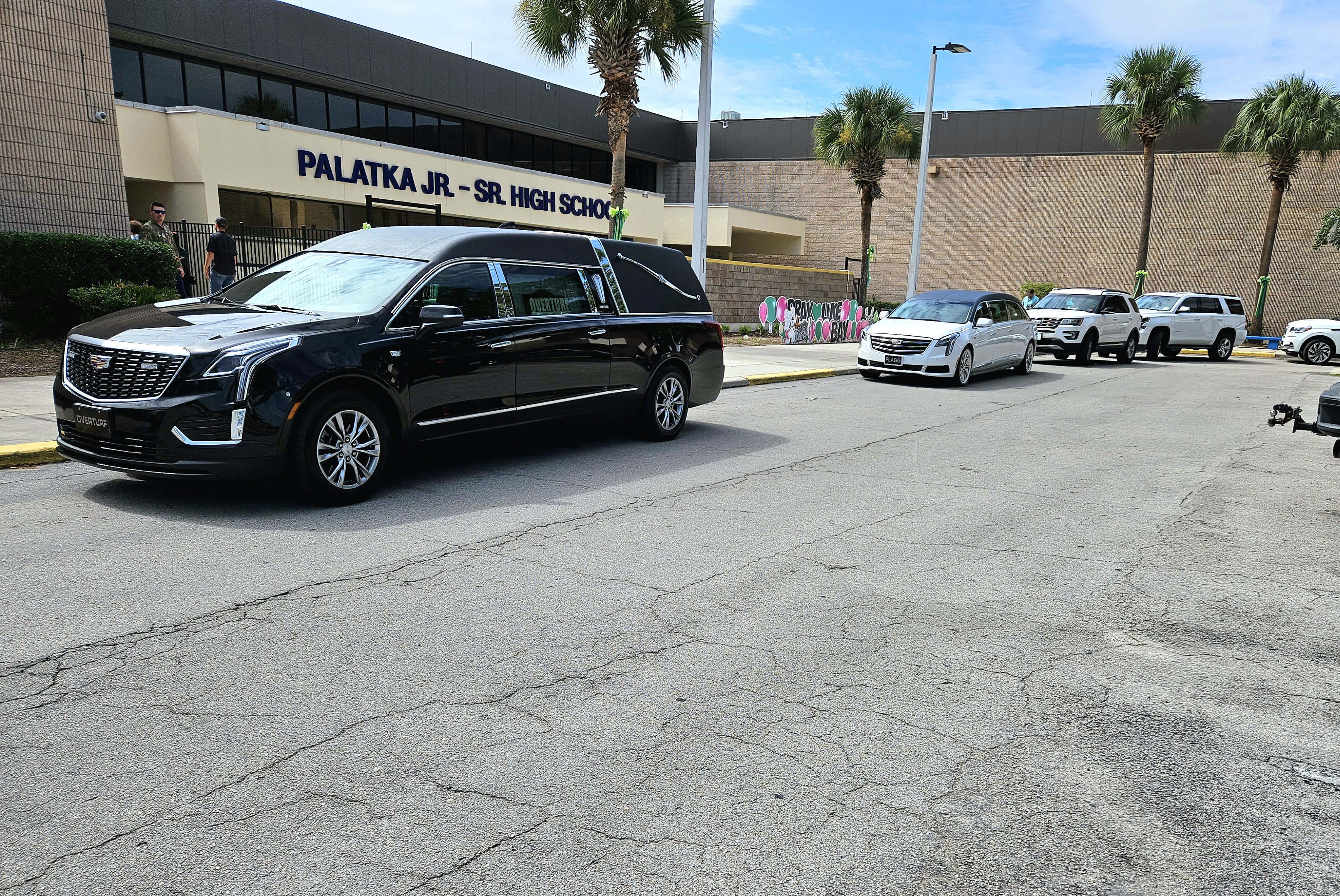 BRANDON D. OLIVER/Palatka Daily News – Funeral home vehicles are lined up outside Palatka Junior-Senior High School on Saturday.