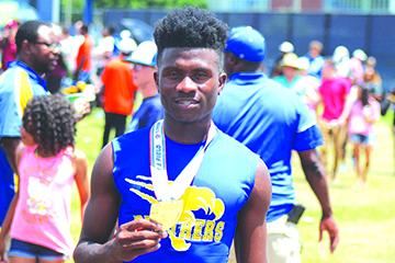 Treyvon Williams shows off his gold medal he won in the 400-meter dash at the FHSAA 2A championship at the University of North Florida on May 4. (MARK BLUMENTHAL / Palatka Daily News)