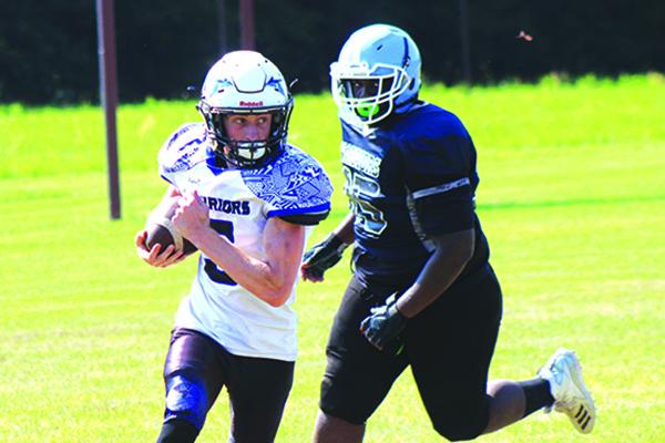 Peniel Baptist’s Andrew Dennin looks upfield against Newberry Christian in the spring game. (ANDY HALL / Palatka Daily News)