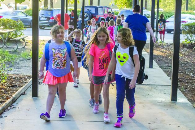 Students walk into Interlachen Elementary School on Monday morning on their first day of school.