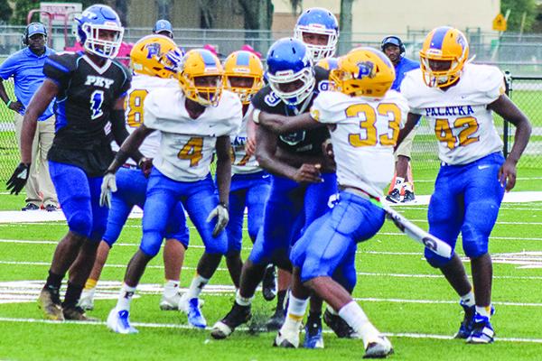P.K. Yonge quarterback Jontez Williams churns for yards while Palatka defenders, most notably Shemar Curry (33), try to take him down during Saturday’s game at Bradford High School. (ANDY HALL / Palatka Daily News)