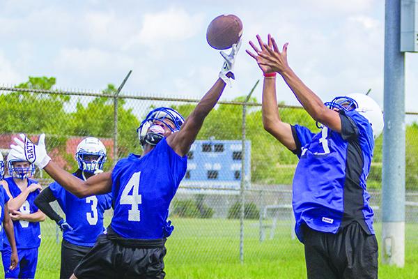 Interlachen’s Thomas Mack (4) goes up to block a pass to William Cruz (23) at the first preseason practice on July 29. Mack caught seven passes and had a 50-yard punt return last Friday. (FRAN RUCHALSKI / Palatka Daily News)