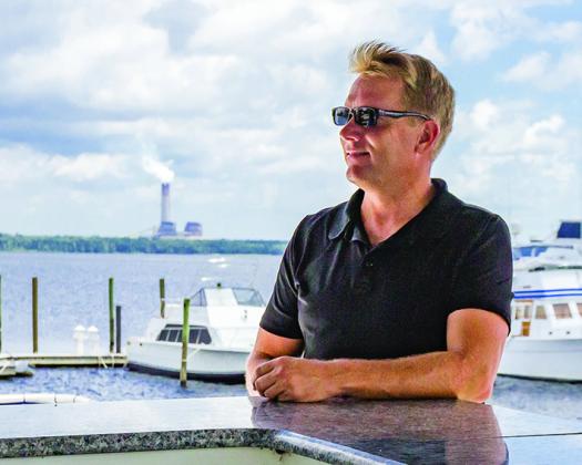 Kelly Redford says living on a boat is a way of life as he stands on the upper deck of his 62-foot houseboat and surveys the view he enjoys every day.
