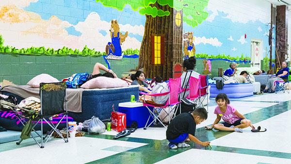 Children play at an emergency shelter at Browning-Pearce Elementary School.
