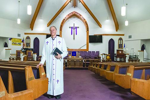 The Rev. Karl Flagg stands in the sanctuary of Mt. Tabor First Baptist Church.