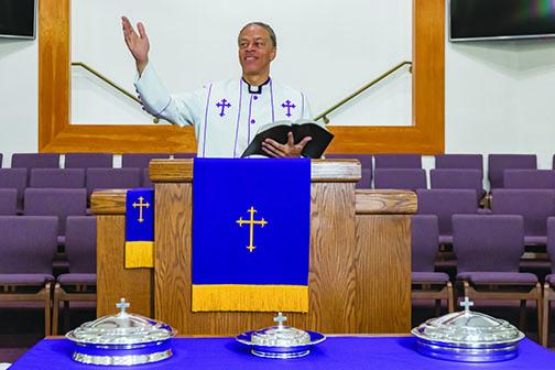 The Rev. Karl Flagg stands in the sanctuary of Mt. Tabor First Baptist Church.