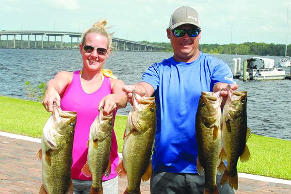 Katy Gray, left, and Lee Stalvey hold up their winning fish. (GREG WALKER / Special To The Daily News)