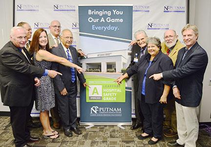 Hospital officials celebrate Putnam Community Medical Center being given safety and quality awards.