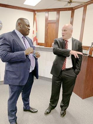 Palatka Mayor Terrill Hill talks with newly-appointed city manager William Shanahan.