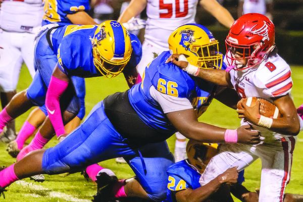 Palatka defenders James Matthews (66) and Kamari Betts (24) combine to tackle Bradford’s Pedro Carter in the second quarter Oct. 18. (Daily News file photo)