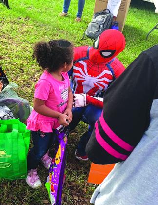 Jonathan Garcia distributes costumes during last year's event.