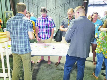 Visitors at Saturday’s Palatka Craft Beer Festival discuss ideas for downtown development as part of the St. Johns Avenue Streetscape Project. 