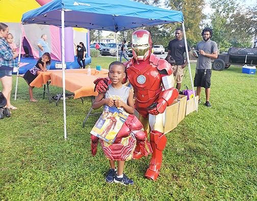Children receive Halloween costumes during Costumes for Kids.
