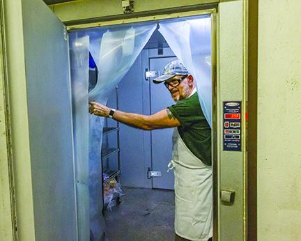 Ronny Tomas stands in the cooler at Bread of Life's Fifth Street building in Palatka.