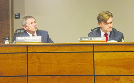 Superintendent Rick Surrency and attorney Jett Baumann listen to matters at Tuesday’s Putnam County School District board meeting.