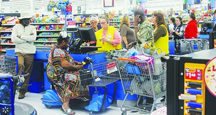 Cashiers assist customers at Walmart in Palatka.