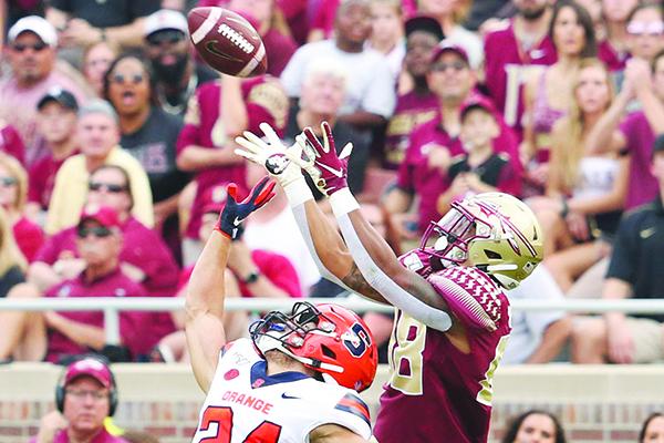 Florida State’s Tre’Shaun Harrison outleaps Syracuse defender Allen Stritzinger in their game Oct. 26. (GREG OYSTER / Special To The Daily News)