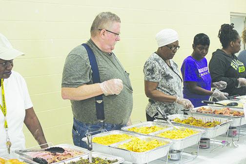 Volunteers prepare to pass out food Tuesday.