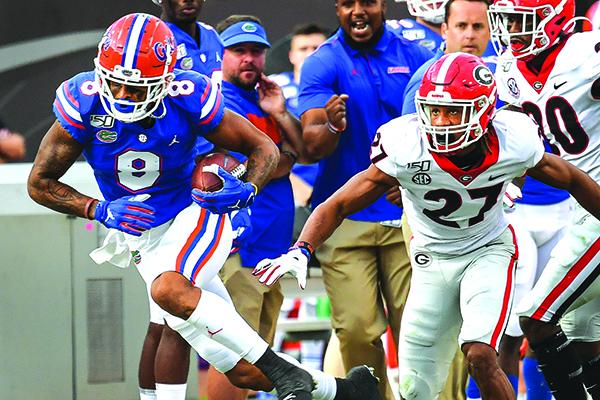 Florida’s Trevon Grimes pulls away from Georgia’s Eric Stokes in Saturday’s game. (JOHN STUDWELL / Special To The Daily News)