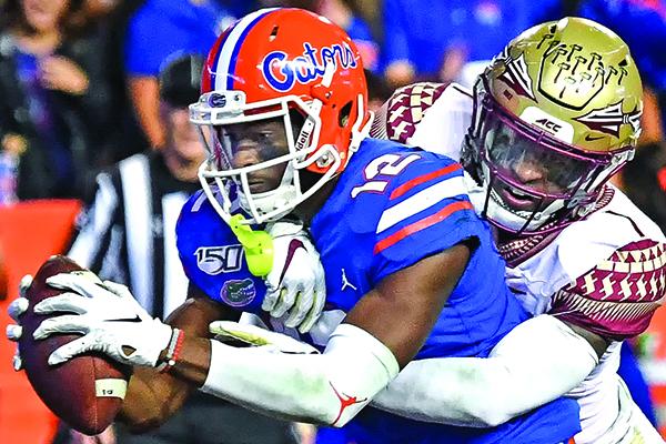 Florida's Van Jefferson crosses over the goal line with the ball for a touchdown Saturday night against Florida State. (JOHN STUDWELL / Special To The Daily News)