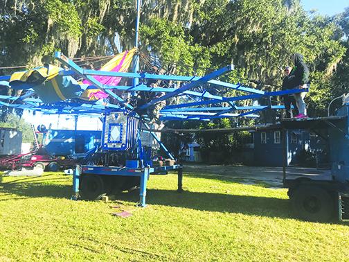 Workers set up rides for this year's carnival.
