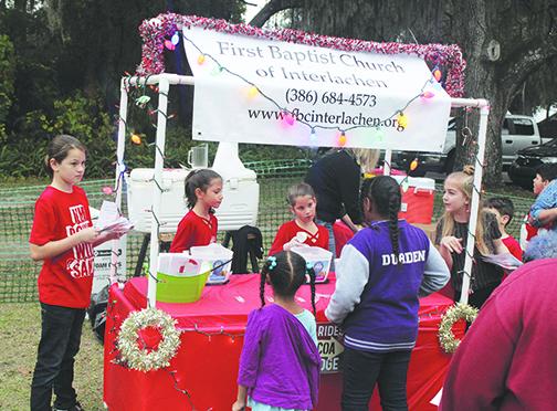Children from First Baptist Church of Interlachen hand out hot cocoa during Saturday's Christmas Celebration in Interlachen.