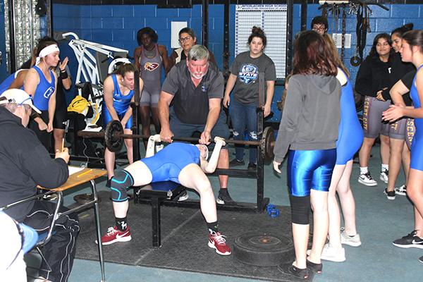 Interlachen High School girls weightlifting coach Ron Whitehurst spots one of his lifters during the county championship at Interlachen High School Wednesday. (ANDY HALL / Palatka Daily News)