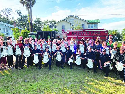 Local firefighters celebrate receiving new equipment Thursday afternoon.